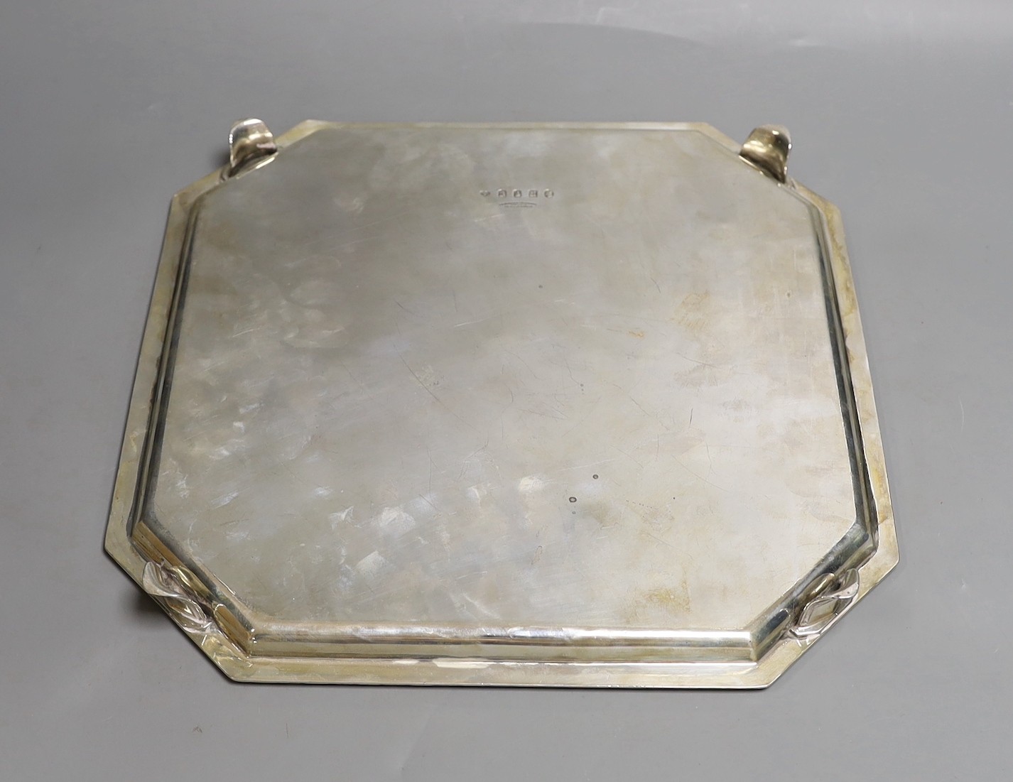 A George V silver octagonal salver, on swept feet, with engraved border, Goldsmiths & Silversmiths Co Ltd, London, 1935, 34.7cm